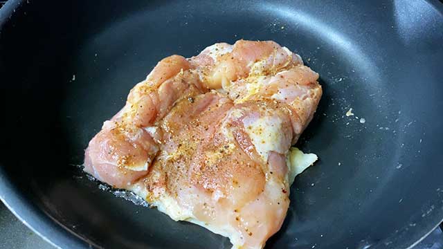 フライパンを弱火で熱しながら、皮の方を下にして鶏肉をフライパンに入れる